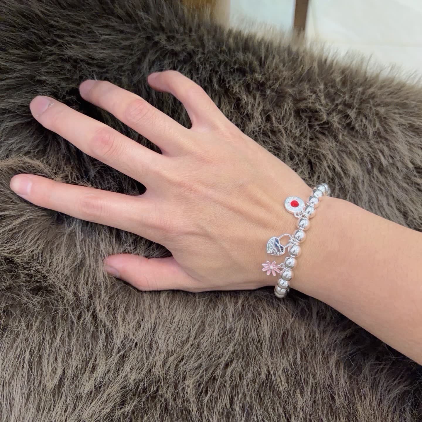 Tiffany & Co. Sterling Silver Bead Bracelet with Lock and Flower Charms
